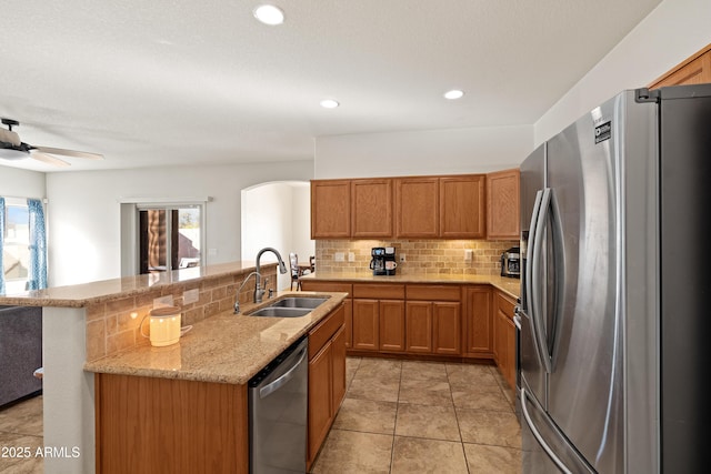 kitchen featuring ceiling fan, sink, plenty of natural light, and appliances with stainless steel finishes