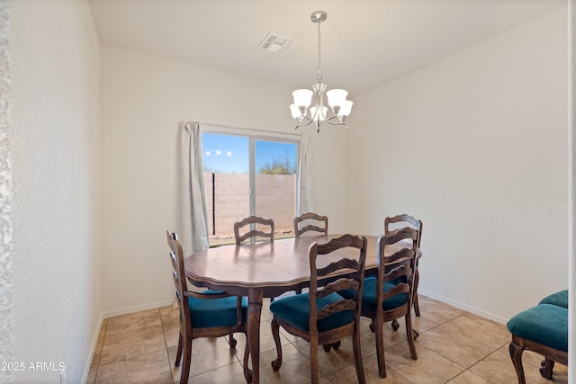 dining area featuring light tile patterned floors and a chandelier