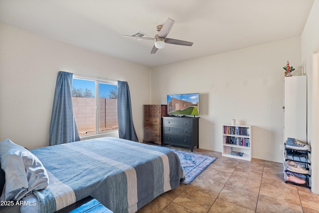 tiled bedroom featuring ceiling fan