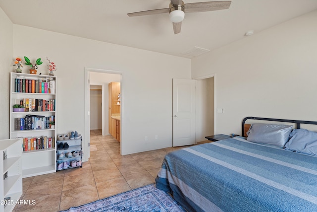 bedroom featuring ceiling fan, light tile patterned flooring, and ensuite bathroom