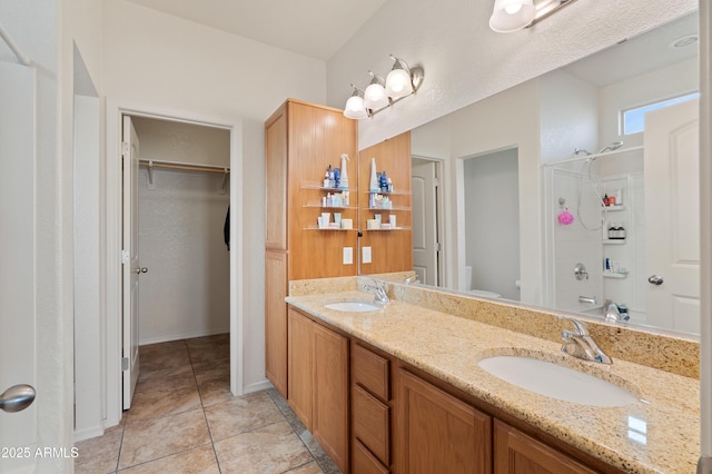 bathroom with tile patterned flooring, vanity, and toilet