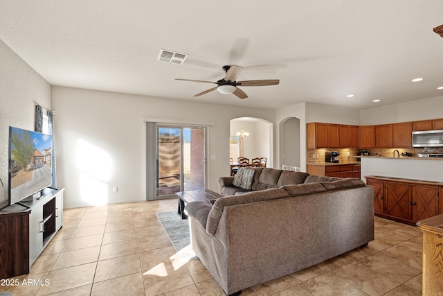 living room featuring ceiling fan and light tile patterned floors