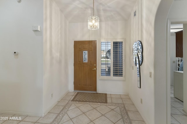 entryway featuring a chandelier and light tile patterned flooring