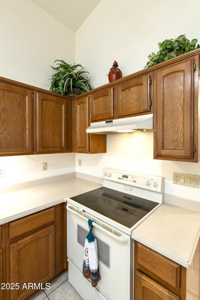 kitchen with electric stove and light tile patterned flooring