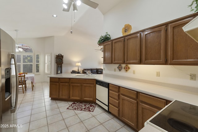 kitchen with sink, light tile patterned floors, kitchen peninsula, pendant lighting, and white appliances