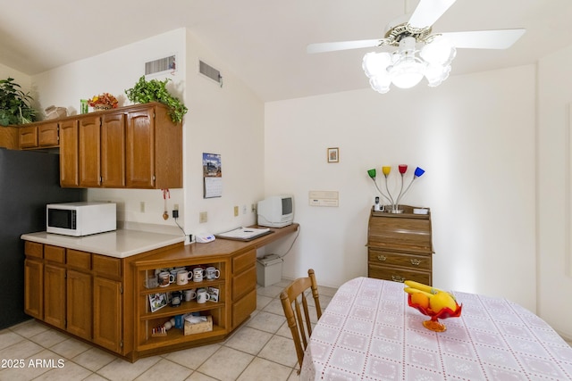 kitchen featuring light tile patterned floors and ceiling fan