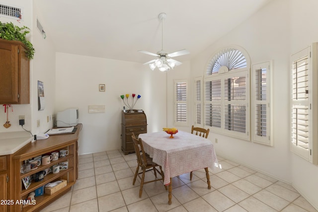 tiled dining space with ceiling fan