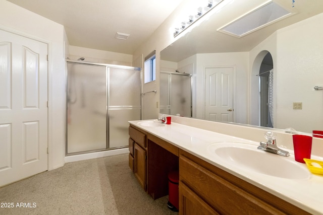 bathroom with vanity and a shower with shower door