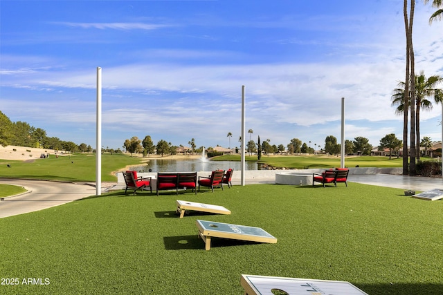 view of home's community featuring a water view and a yard