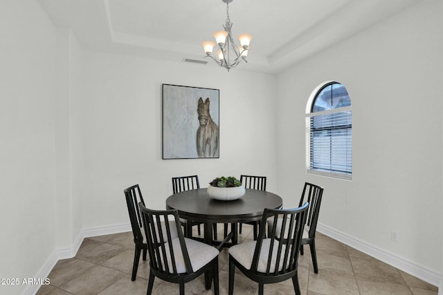 7917 S 32nd Ter, Phoenix, AZ 85042 - dining room featuring light tile patterned floors, a tray ceiling, and a chandelier