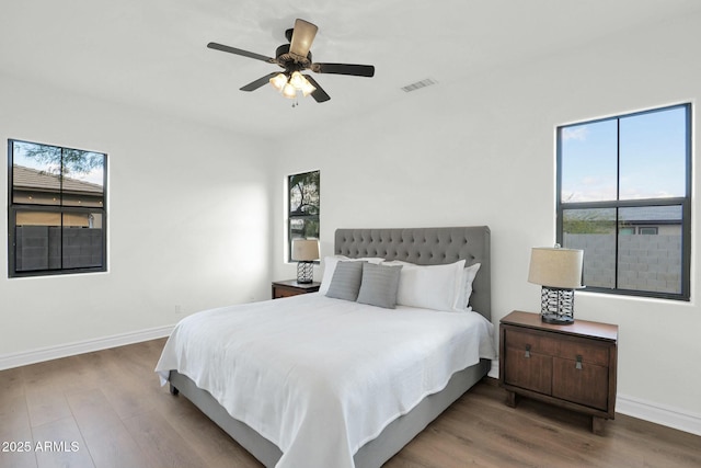 7917 S 32nd Ter, Phoenix, AZ 85042 - bedroom featuring ceiling fan, wood-type flooring, and multiple windows