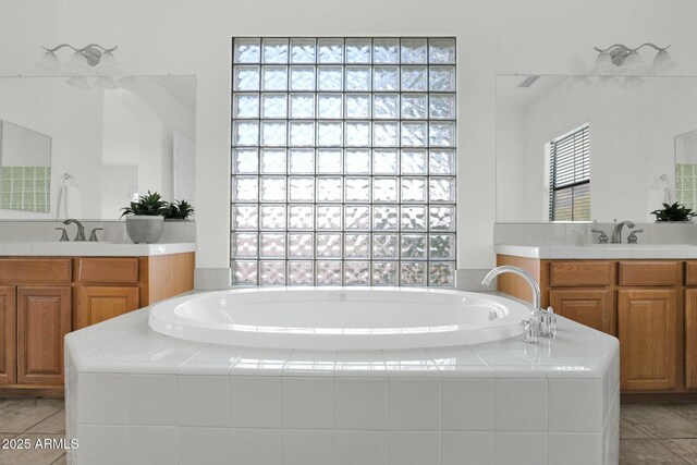 7917 S 32nd Ter, Phoenix, AZ 85042 - bathroom with vanity, a relaxing tiled tub, and tile patterned floors