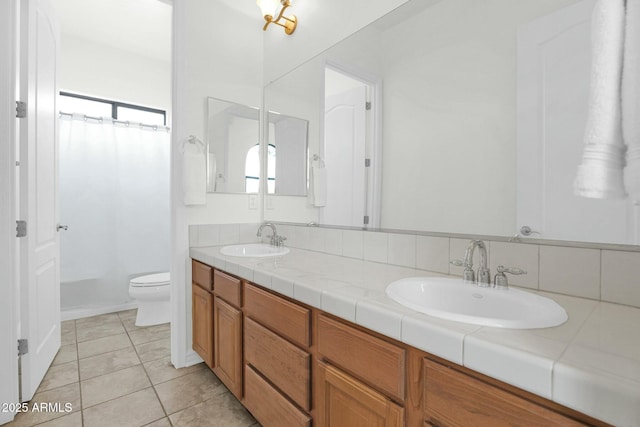 7917 S 32nd Ter, Phoenix, AZ 85042 - bathroom featuring tile patterned flooring, vanity, backsplash, and toilet