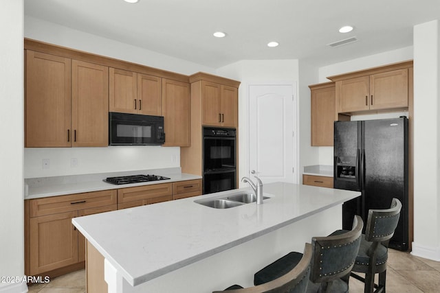 7917 S 32nd Ter, Phoenix, AZ 85042 - kitchen with sink, an island with sink, a breakfast bar area, and black appliances