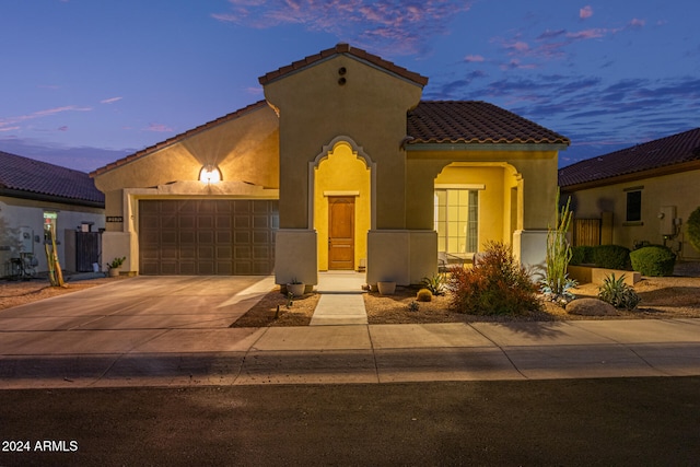 mediterranean / spanish-style home featuring a garage