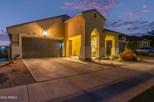 mediterranean / spanish-style home featuring a garage