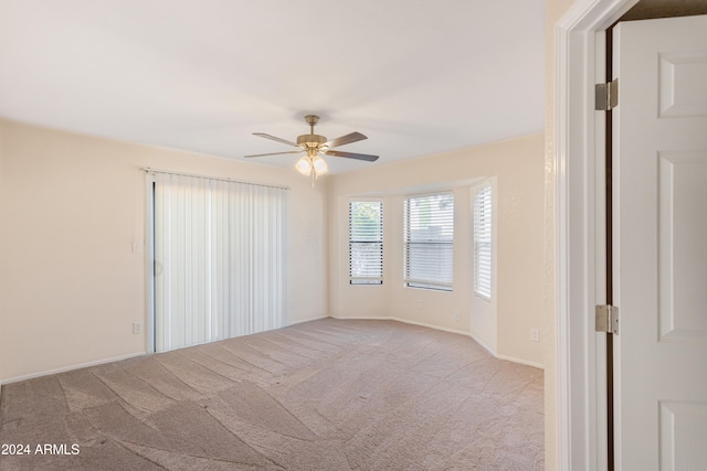 carpeted empty room featuring ceiling fan