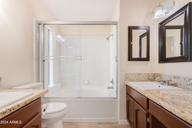 full bathroom with toilet, vanity, and shower / bath combination with glass door