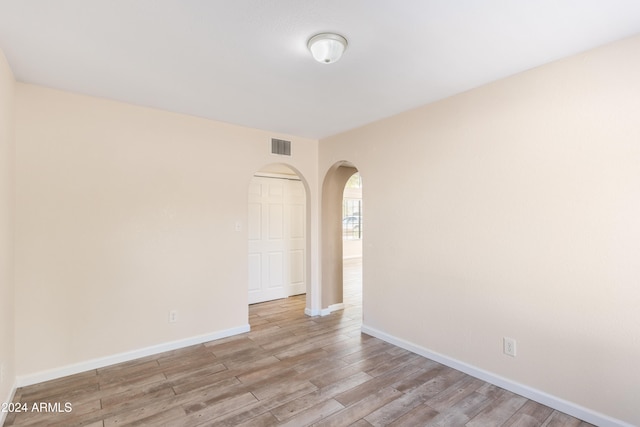 unfurnished room with light hardwood / wood-style floors