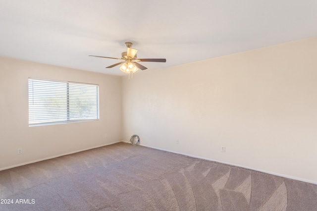 spare room featuring carpet flooring and ceiling fan