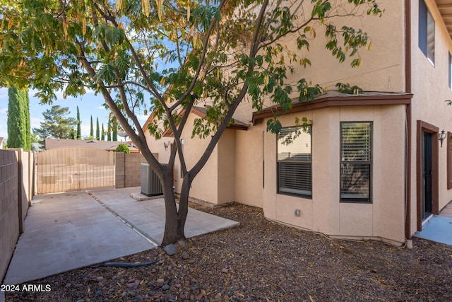 view of home's exterior with central AC unit and a patio