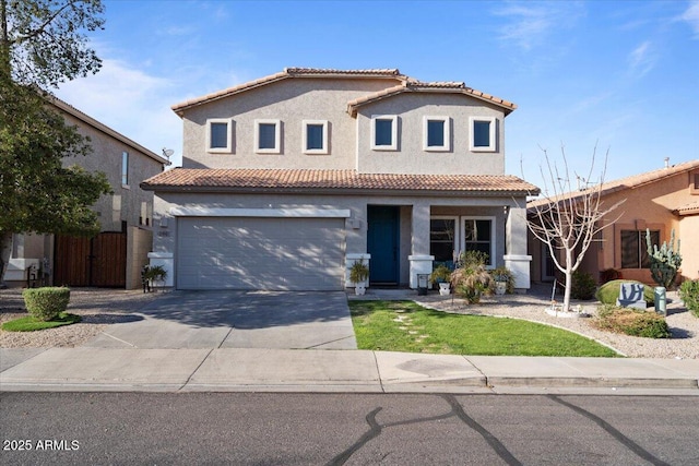 view of front of home with stucco siding, an attached garage, driveway, and a tiled roof