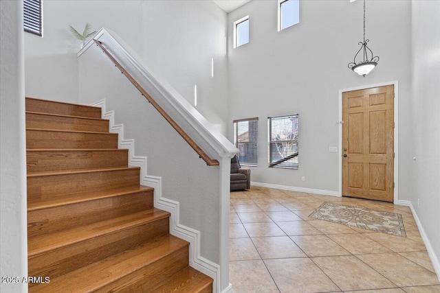 foyer entrance featuring stairway, plenty of natural light, and tile patterned flooring