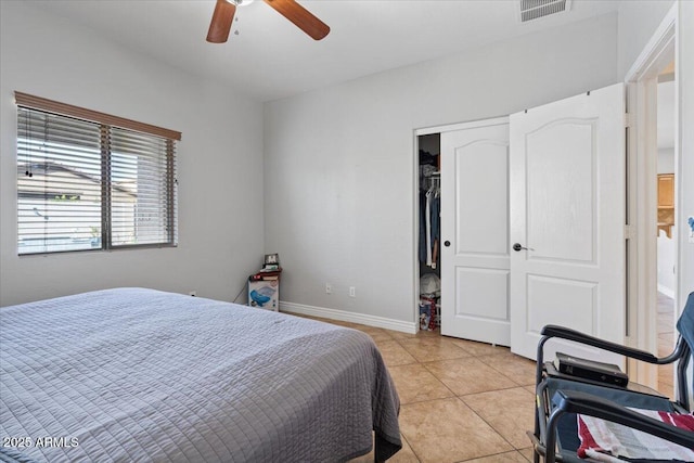 bedroom featuring a ceiling fan, light tile patterned floors, baseboards, and visible vents