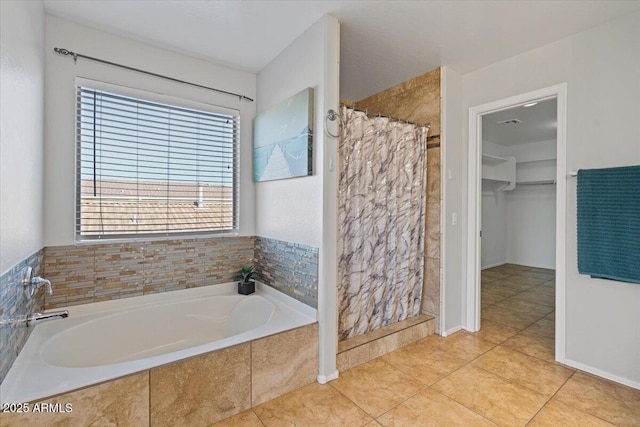 full bath with tile patterned flooring, a shower stall, a spacious closet, and a bath