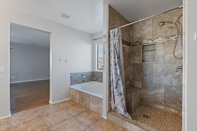 full bath with tile patterned floors, visible vents, a bath, and a shower stall