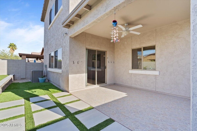 view of patio / terrace featuring central AC unit, ceiling fan, and fence