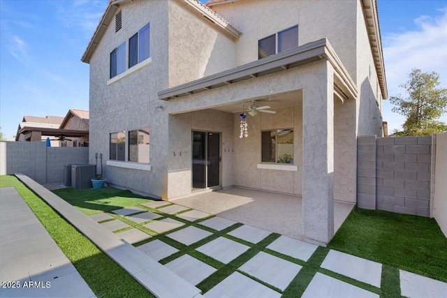 rear view of house featuring stucco siding, a ceiling fan, a patio, central AC, and fence