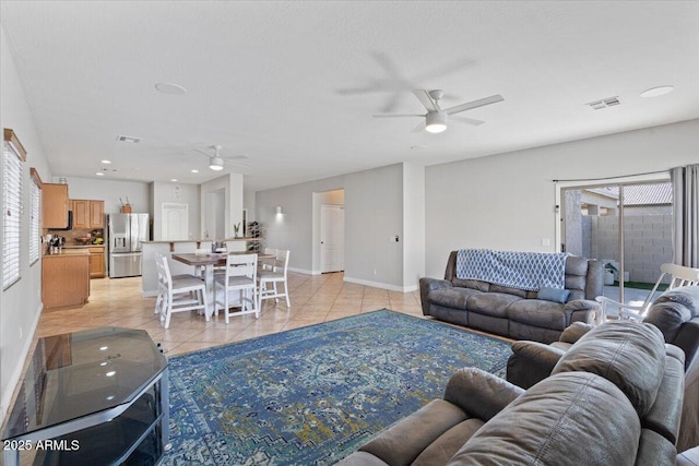 living room featuring a ceiling fan, visible vents, baseboards, light tile patterned flooring, and recessed lighting