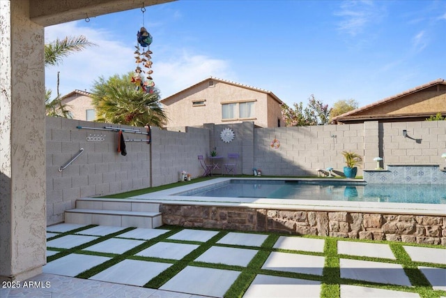 view of swimming pool featuring a fenced in pool, a fenced backyard, and a patio area