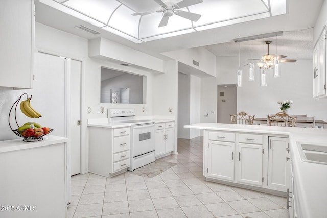 kitchen with ceiling fan, electric range oven, white cabinetry, and kitchen peninsula