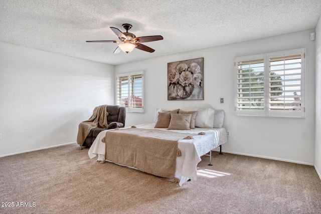 bedroom with carpet, multiple windows, a textured ceiling, and ceiling fan