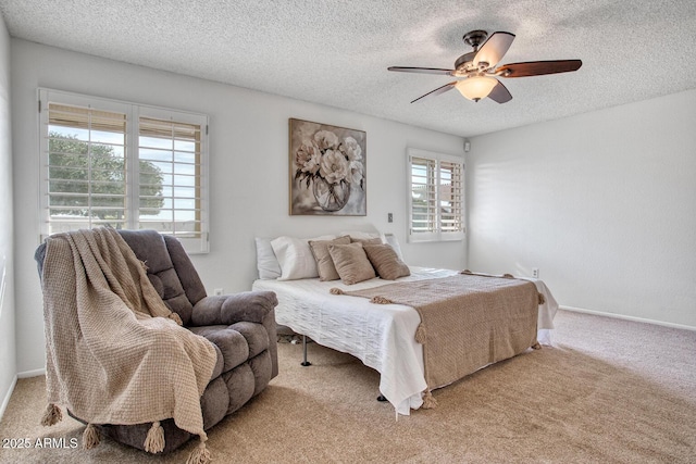 carpeted bedroom with ceiling fan and a textured ceiling