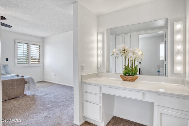 bathroom with ceiling fan and vanity