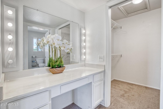 bathroom featuring toilet and vanity