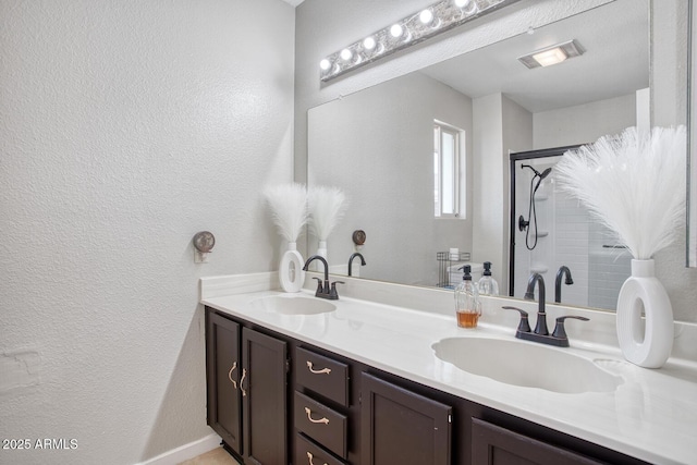 bathroom featuring a shower and vanity