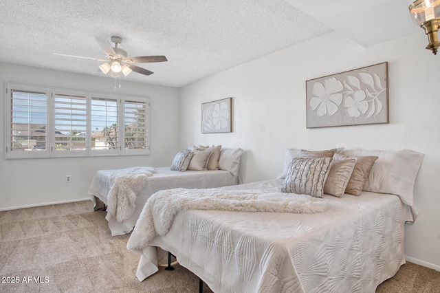 bedroom featuring a textured ceiling, carpet floors, and ceiling fan