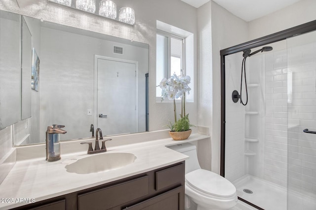 bathroom featuring toilet, walk in shower, and vanity