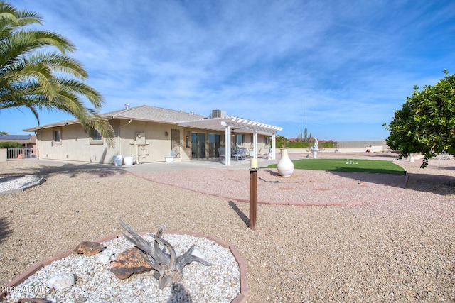 rear view of property with a patio and a pergola