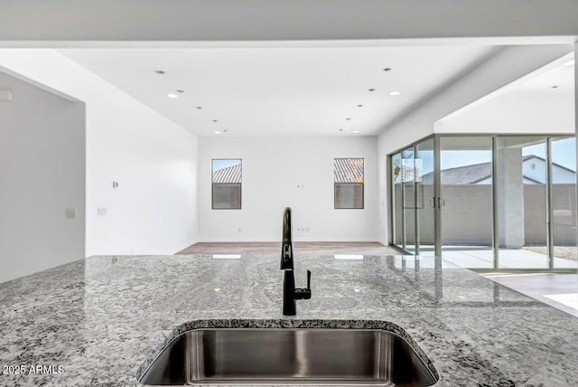 kitchen with sink and light stone countertops