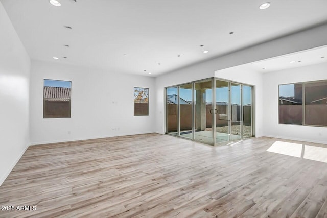 empty room with light hardwood / wood-style floors