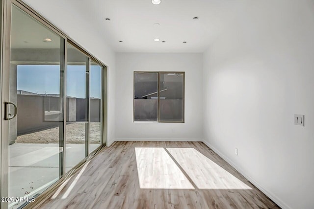 unfurnished room featuring light hardwood / wood-style floors