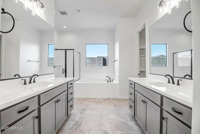 bathroom with independent shower and bath and vanity