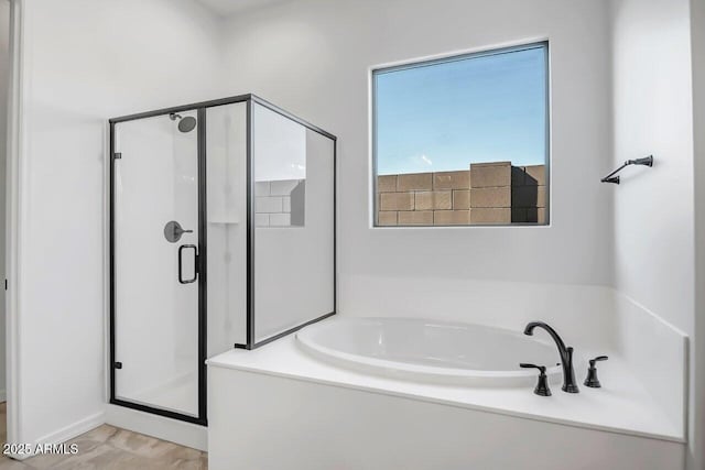 bathroom with shower with separate bathtub