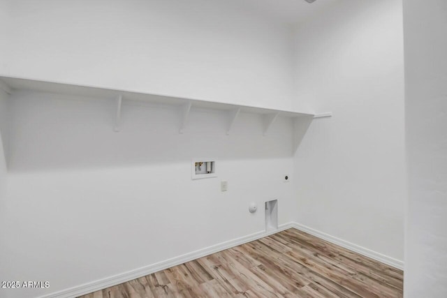 clothes washing area featuring gas dryer hookup, light hardwood / wood-style floors, hookup for a washing machine, and electric dryer hookup