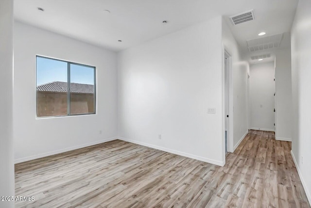 empty room with light hardwood / wood-style floors